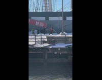 Group of people walk by ocean snow 