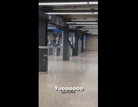 Person walking around with pants at ankles in subway station