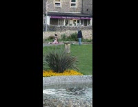 Girl pink leggings yoga stretch pose fountain