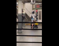 Woman fix space man suit at station