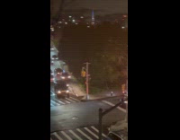 Police officers pushes car blocking the road