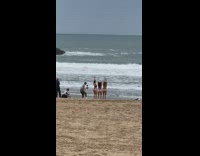 Three Ladies in Bikinis Show Off their Backs at Beach 