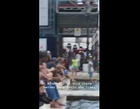 Girl white dress stand stone port crowd