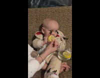 Lady Have Baby Taste a Slice of Lemon