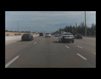 Overspeeding car on highway hits another cars side mirror 