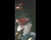 Guy holds orange cone shoots firework park