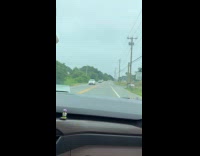 Guy drives street full of smoke shop