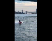 Man cosplay joker ride jet ski on river
