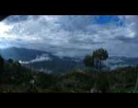 Clouds Disperse as Sunlight Shines on Mountains