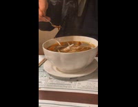 Man puts drop of spice on pho