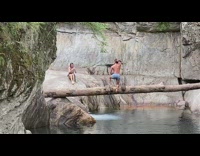 Man blue shorts tree log river pictorial