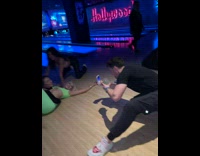 Women lay pose on floor bowling alley