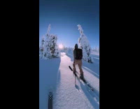 Pink jacket girl skis down mountain 