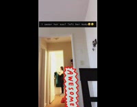 Girl scares friend in bathroom green towel 