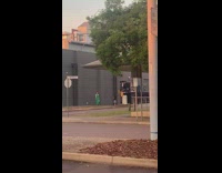 Woman in green dress poses while little girl pictures