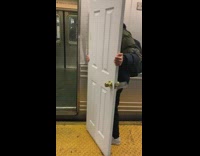 (DUPLICATE) Guy carries entire white door onto subway train