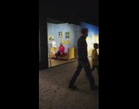 Woman in red top sat on the exhibit bed