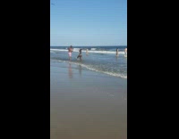 Woman shiny gray bikini dance on the beach