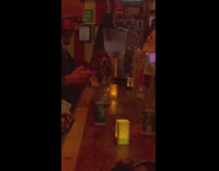 Dog leaning on bar table at the end of bar