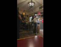 Woman film selfie video near live performer bar