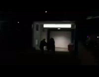 Two guys push friend down ramp in a shopping cart runs into wall