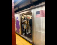 Man on subway wearing predator costume 