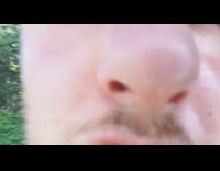 drunk guy filming his face on beach 