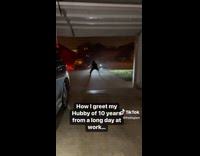 Wife dances on driveway when husband arrives from work 