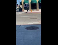 Man sidewalk vlog with phone on tripod