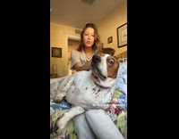 Woman holding up dog ears does gold labubu parody