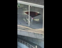 2 guys dance for video in front of fan 