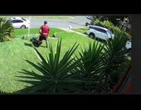 Security cam footage of guy mowing lawn breaks sprinkler
