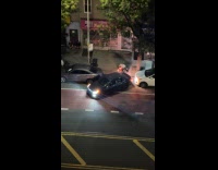 Car reverses on small space at street