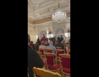 Group of guys trying not to laugh during musical opera performance 
