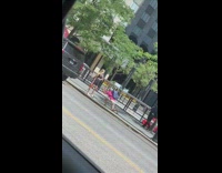 Pink shirt guy kneels sidewalk girl car 