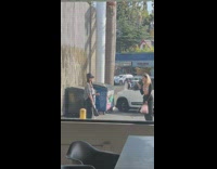 Lady poses in neutral outfit near dumpsters 