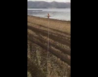 White truck pulls guy red wakeboard lake