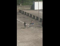 Man shirtless lift two water container empty parking lot