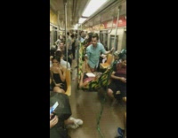 Guy lays on a hammock tied to handrails on the subway