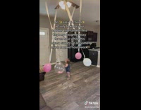 Toddler Plays with Balloons Tied to Ceiling Fan