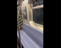 Collab NewYorkers - Man hangs upside down on train handrail