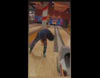 Man Rolls Ball Between Legs and Hits Pin