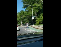 Guy on biker scooter cuts cars 