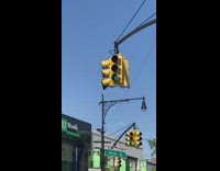Hundreds of bees on yellow stoplight 