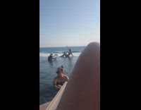 Bikini girl sits poses infinity pool edge 