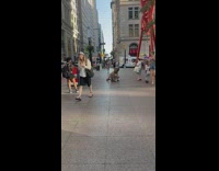 Man rat mask crouch jump on street