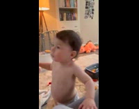 Baby drinks milk from sippy cup then spits