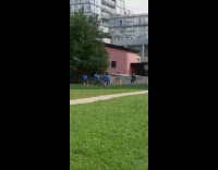 Four girls blue backpacks march across grass