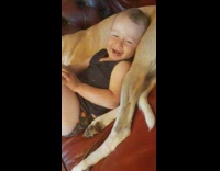 Baby boy lays on dog i love you