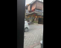 Two guys muscle shirt  motorcycle outside store